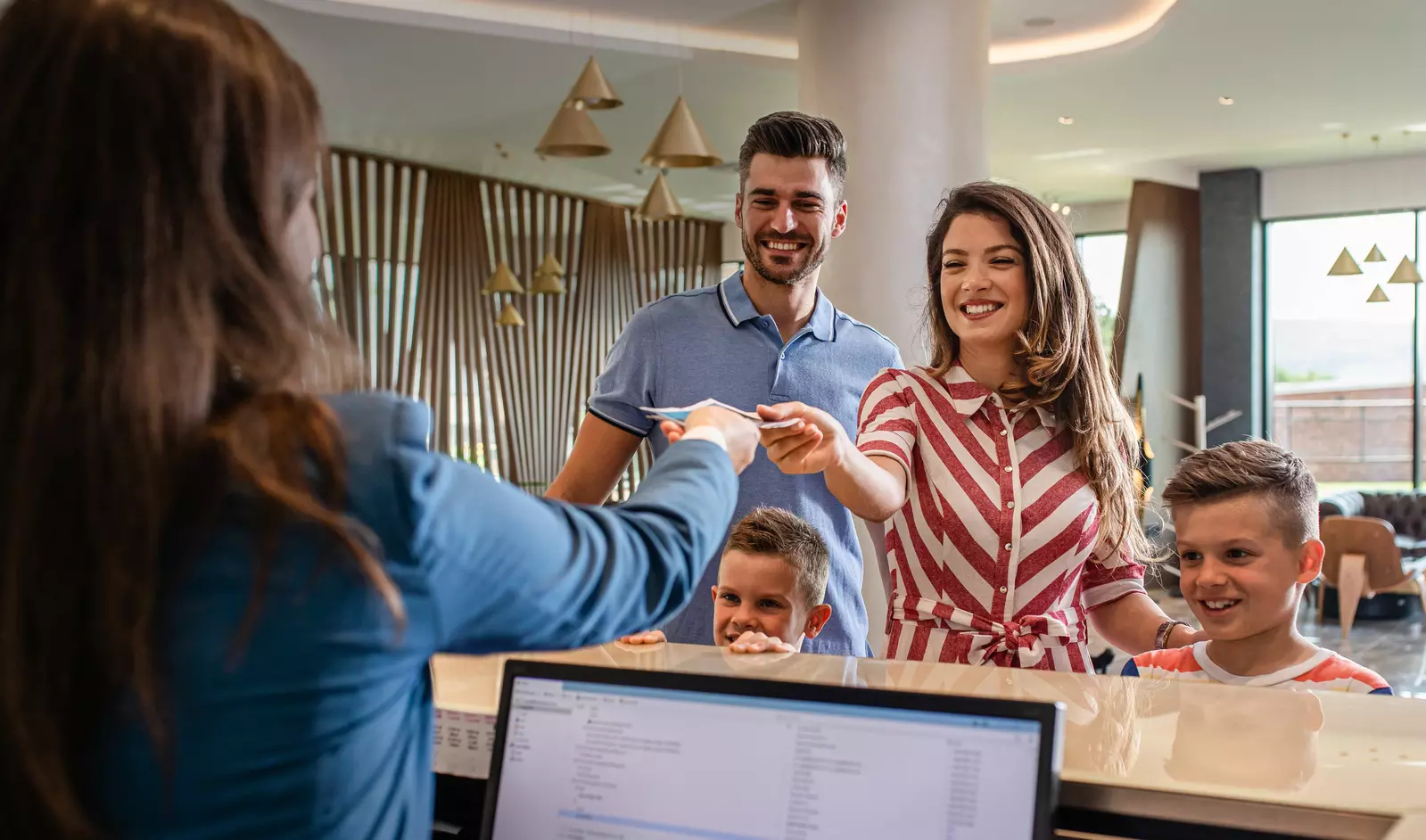Family checking into hotel